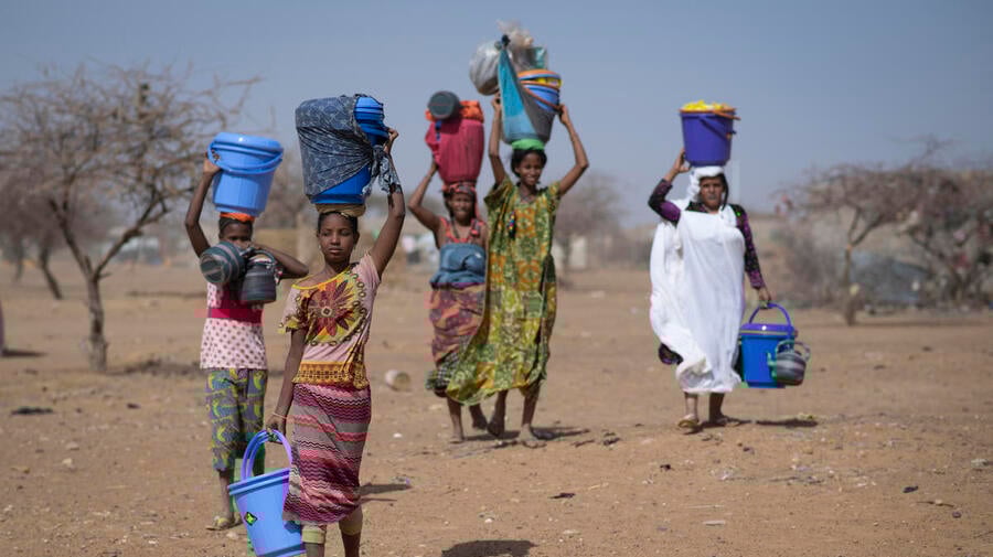 Malian refugees collect aid items at Goudoubo camp, Burkina Faso, February 2020.