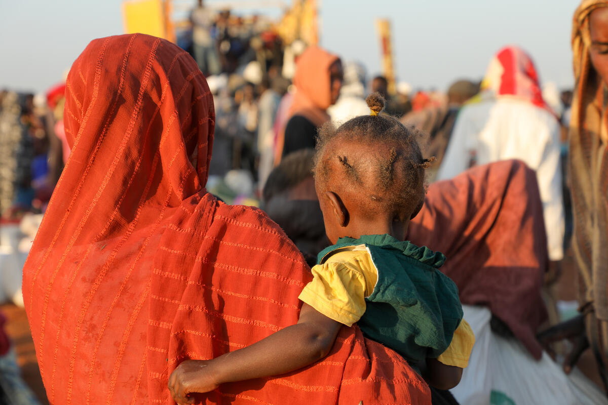 Familien, die vor dem Konflikt im Sudan geflohen sind, warten am überfüllten Grenzpunkt Renk im Südsudan auf ihre Umsiedlung.  © UNHCR / Reason Moses Runyanga