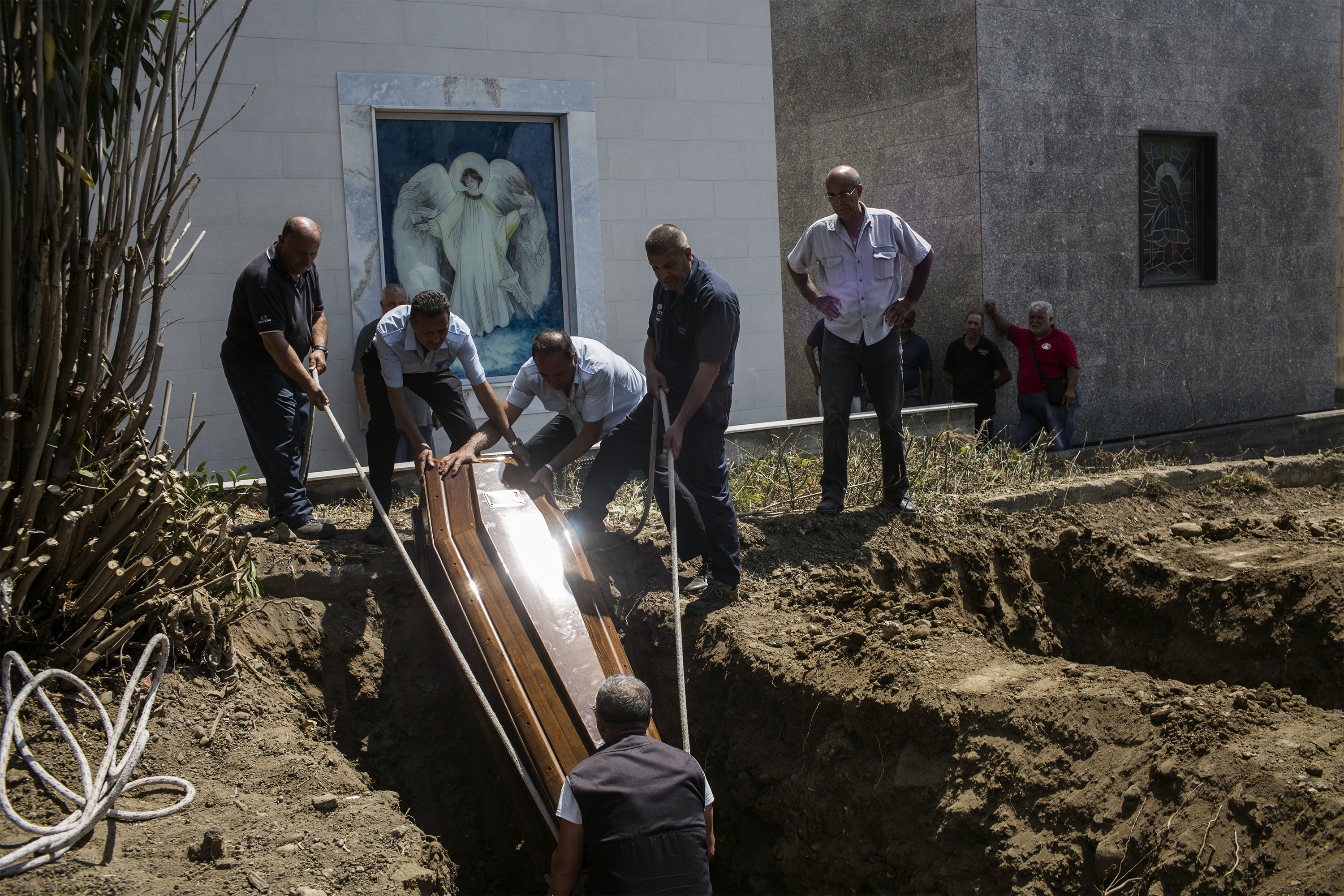 Italy. Burial of refugees.