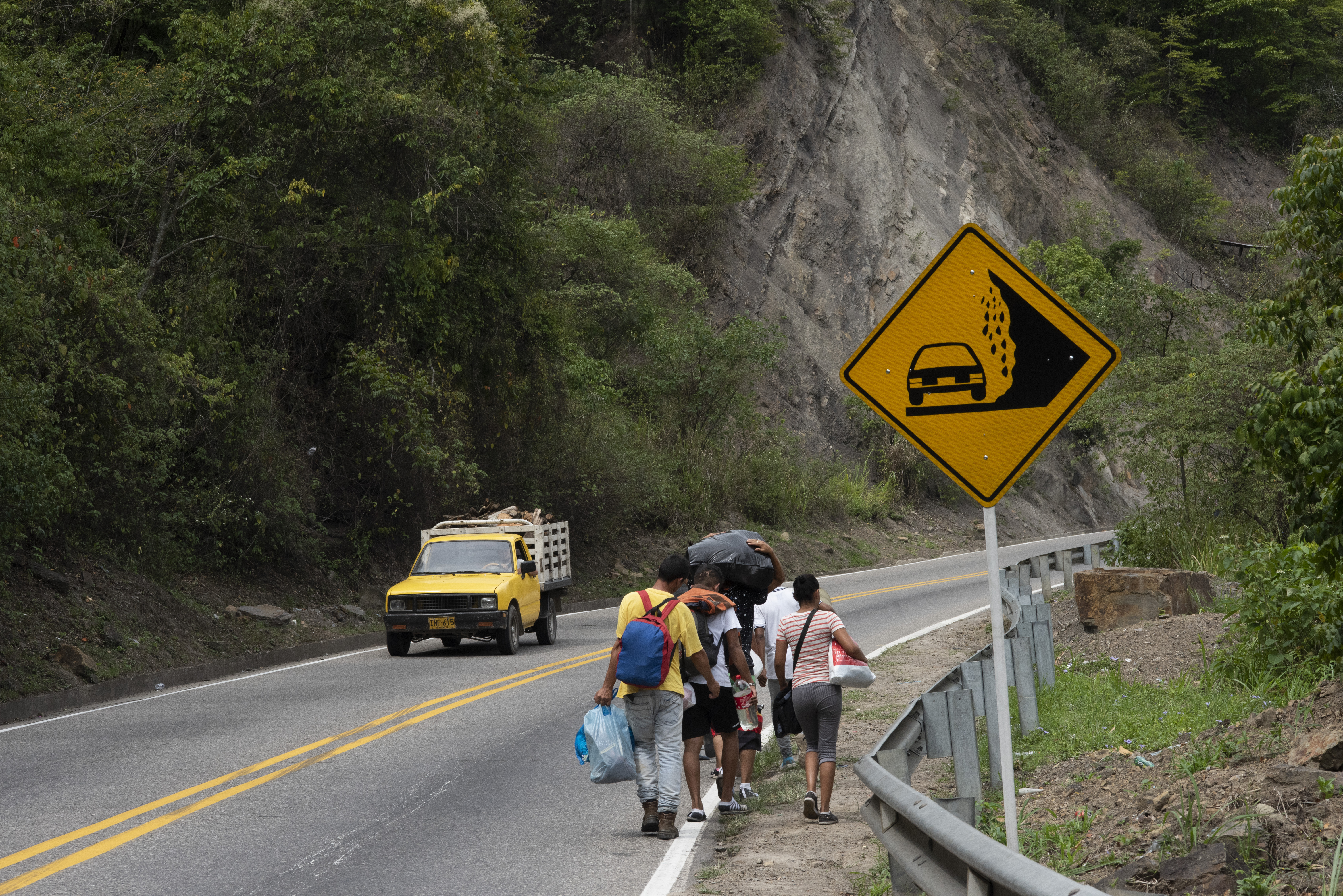 A group of Venezuelans trek along a busy highway between Cúcuta and Pamplona, Colombia.