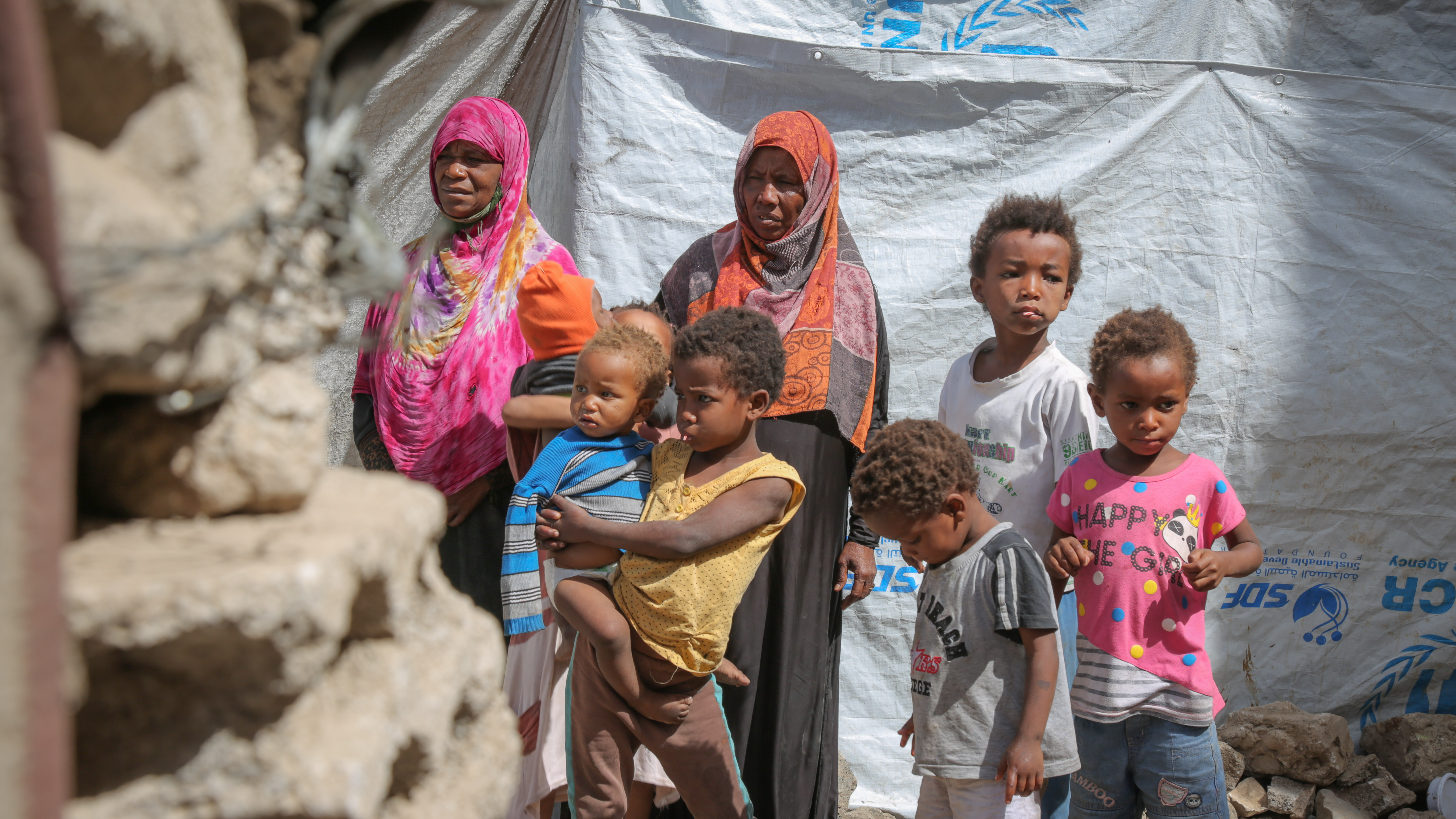 Displaced Yemeni mother, Gabra (in pink) and her family, in a hosting site in Sana'a.