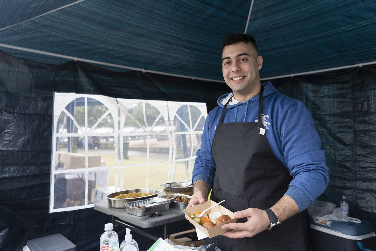 Ed Yusef at his food stall Syriana Traditional Cuisine as Australians walk together with their neighbours from refugee backgrounds around Sydney harbour to celebrate World Refugee Day.