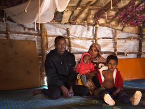 Jafar poses with his wife Zeinabou, their baby daughter Fadimata and they nephew Sidi in their shelter in Mentao refugee camp, Burkina Faso