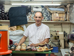 A Syrian refugee and a shoemaker in his thriving workshop in Casablanca after winning a first prize for the most successful enterprising refugee project