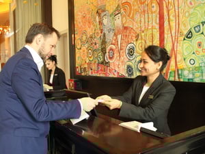 Tajikistan. Afghan refugee Nargis, confidently receiving a guest at the Front Desk, during the Apprenticeship Programme at the renown Sheraton Hotel in Dushanbe