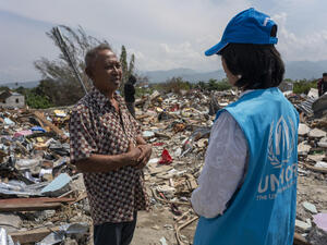 Indonesia. UNHCR staff with survivor of earthquake