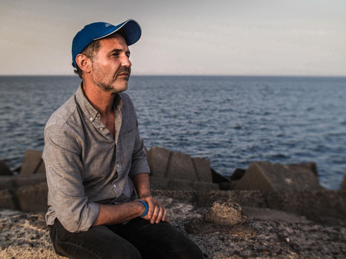 Italy. UNHCR Goodwill Ambassador Khaled Hosseini meets refugees who have survived the perilous sea crossing to Europe