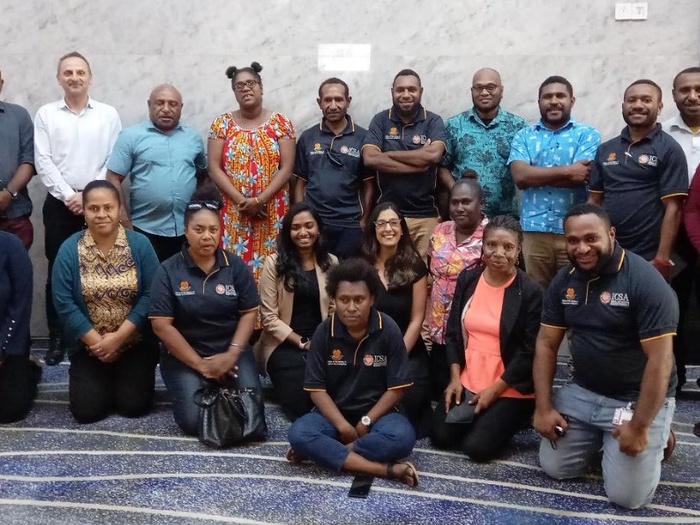 Participants in the training gather together for a group photo