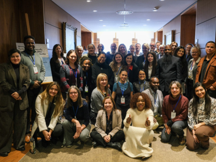 A large group of workshop participants pictured inside