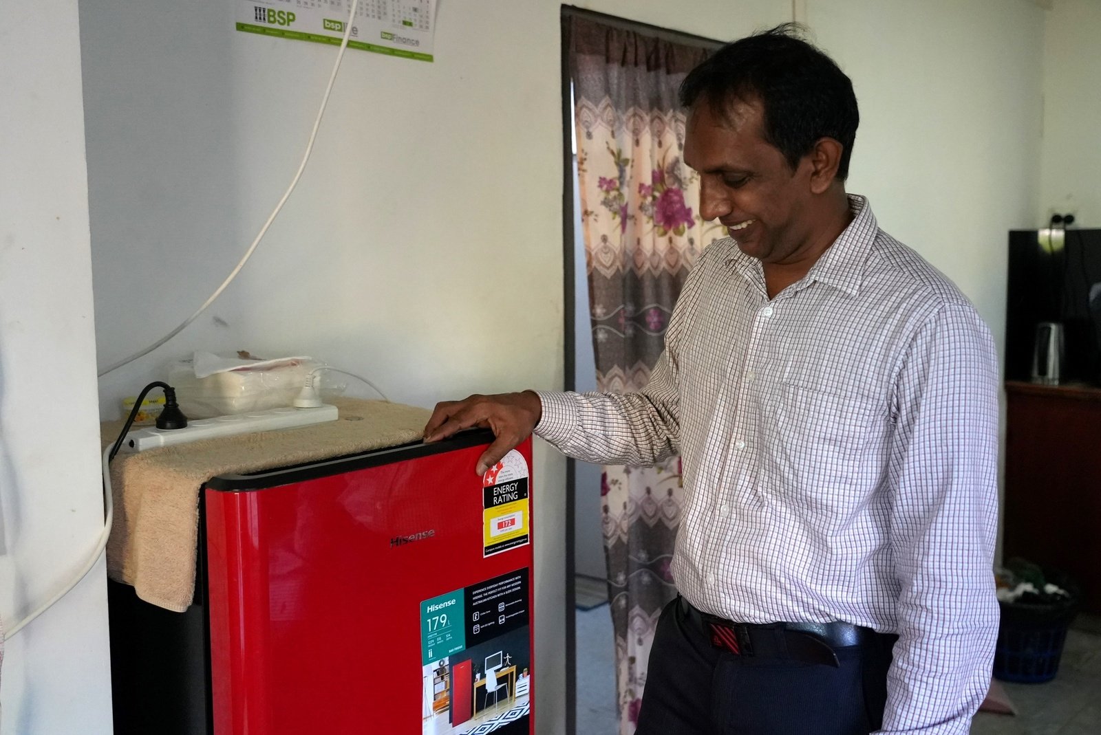 Sebastian admires his fridge