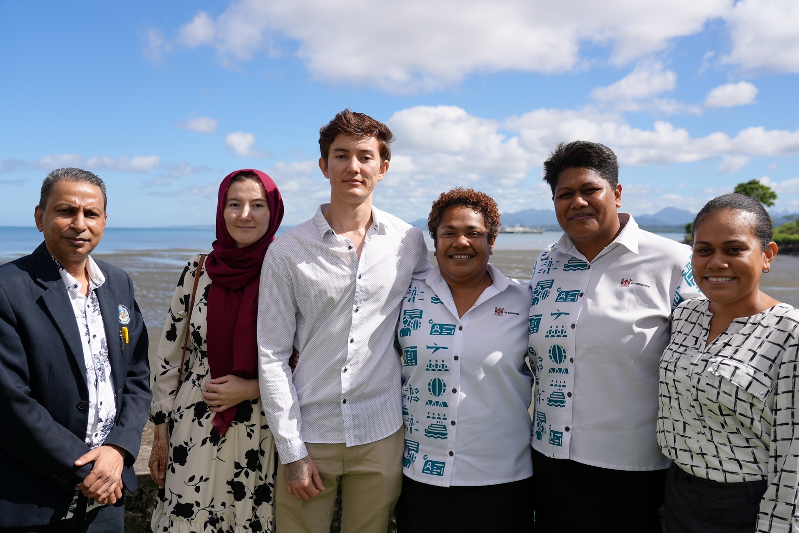 Attendees pose in a group for the camera