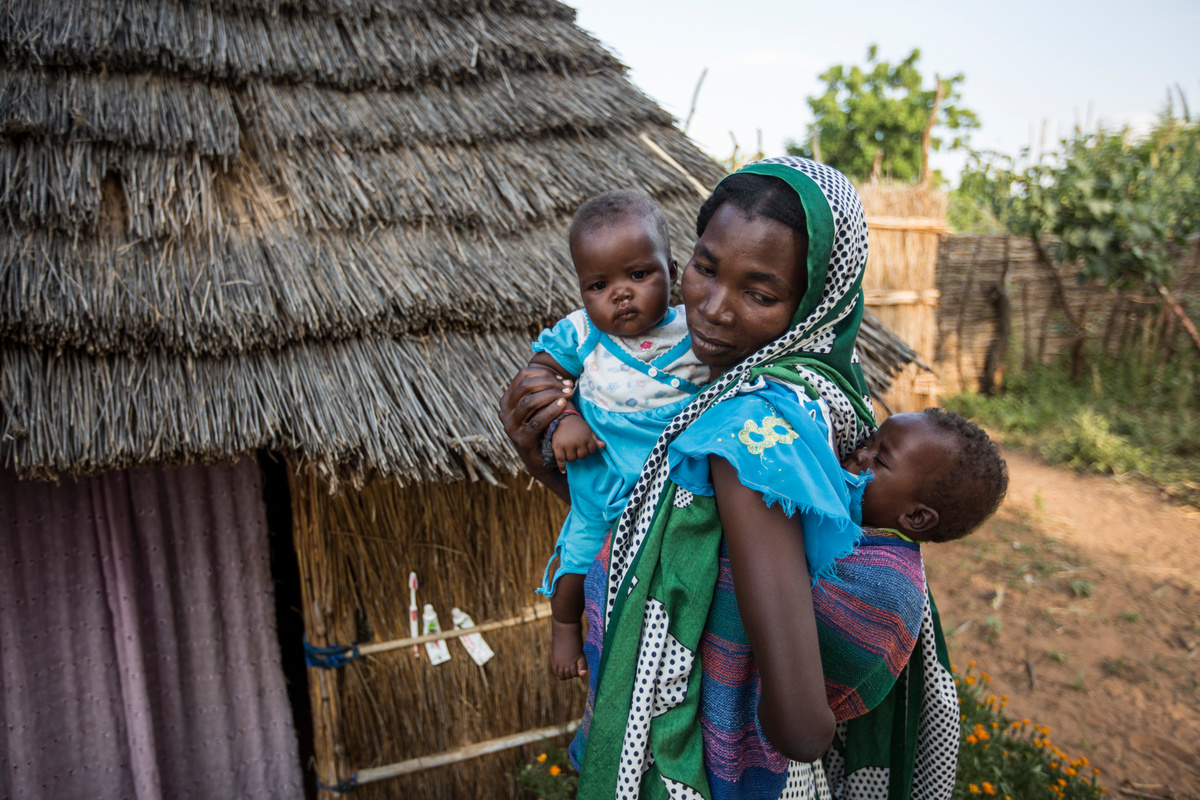 Chad. Refugee mother worries about nutrition of twin babies