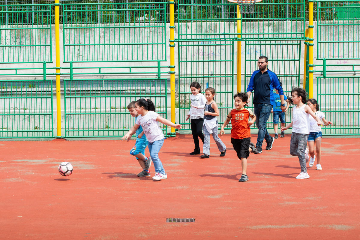 Children play football, one of the programs offered by "The Peace Bridge."