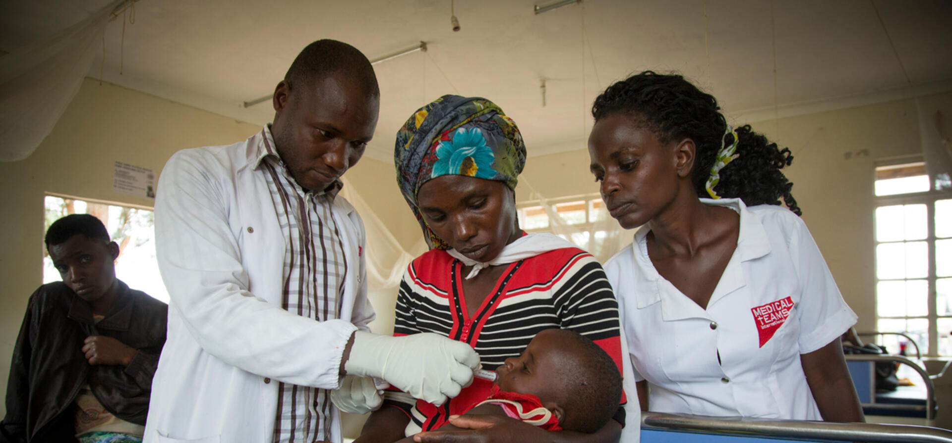 Uganda. Cancer-stricken refugee nurse cares for the sick