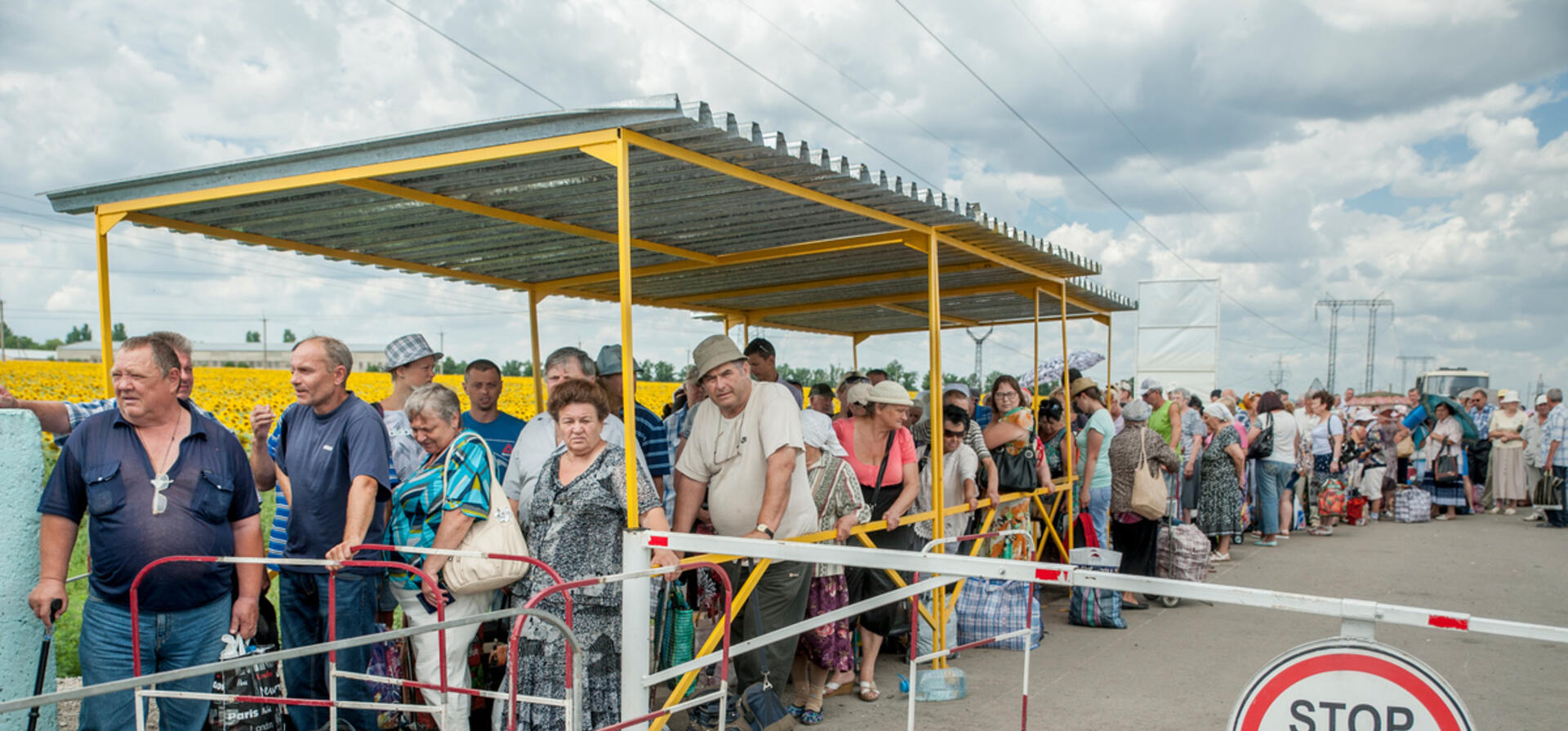 Ukraine. Families wait to pass through a checkpoint in Marinka, close to the conflict zone