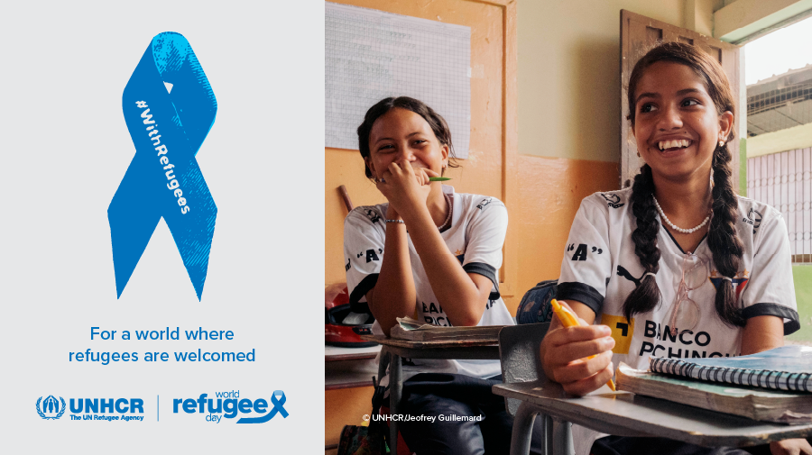 On the right, a picture of two young girls smiling and sitting at their desks in a classroom. On the left, a blue ribbon with the inscription "With Refugees". Text under the ribbon reads: "For a world where refugees are welcome".