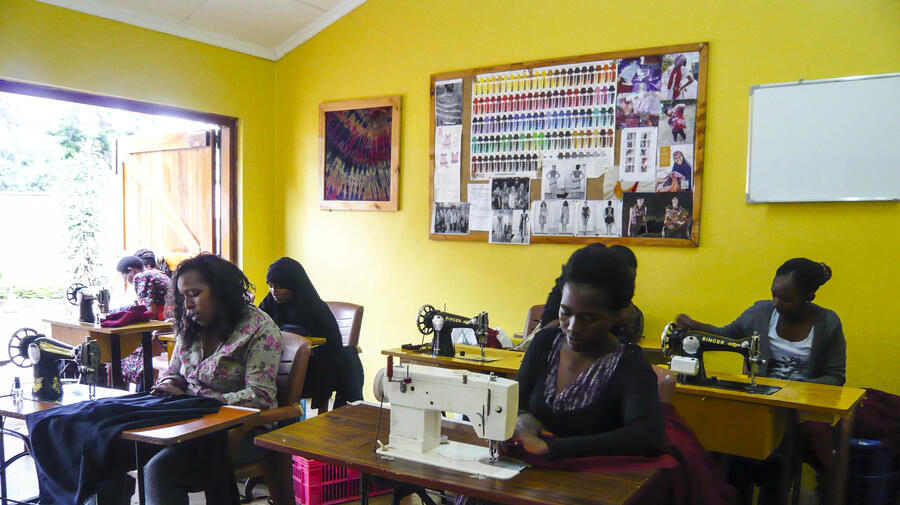 In their sunny Nairobi workshop, refugee women in Heshima's Maisha Collective concentrate on turning out school uniforms.