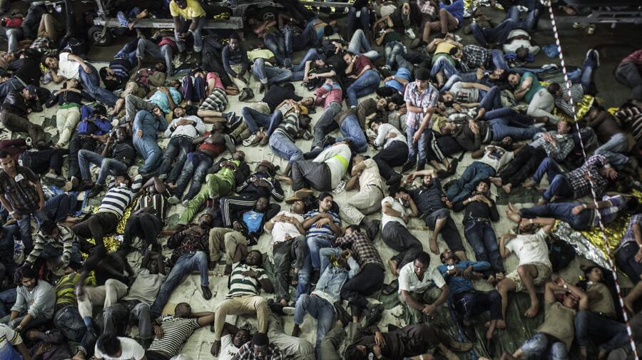 Asylum-seekers and economic migrants take to the seas, waiting out the dangerous journey in the boat's cramped cargo space.