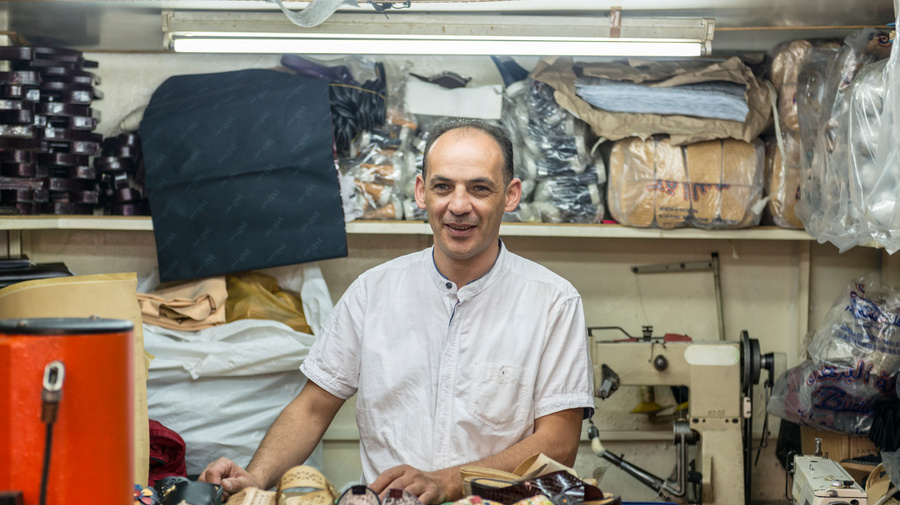 A Syrian refugee and a shoemaker in his thriving workshop in Casablanca after winning a first prize for the most successful enterprising refugee project