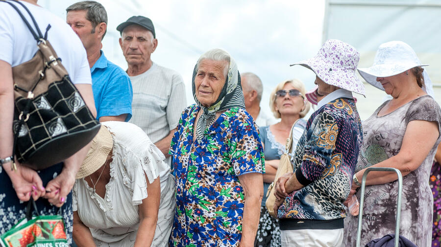 People queue at a checkpoint in Marinka, close to the conflict zone in eastern Ukraine, July 2016.