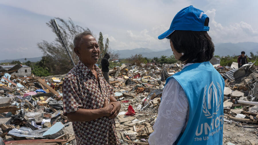 Indonesia. UNHCR staff with survivor of earthquake