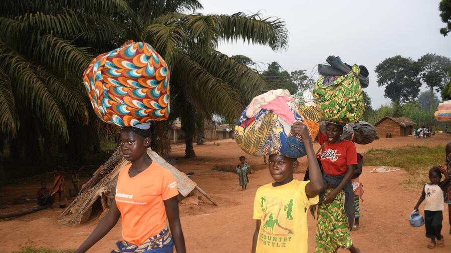 Families arrive in Ndu village in the Democratic Republic of the Congo after fleeing Bangassou town in the Central African Republic.