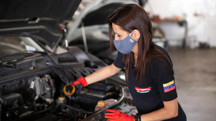 Displaced Venezuelan Samira works as a mechanic in the car repair workshop she runs in Salta, Argentina.