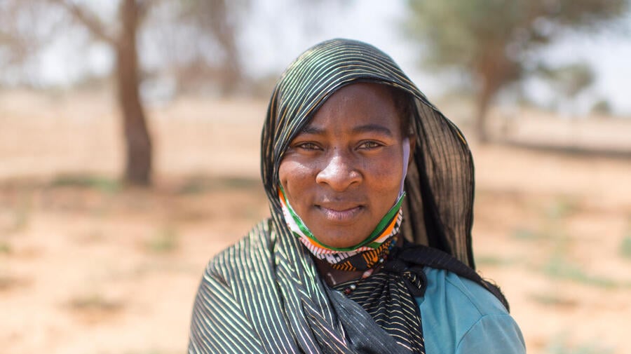 Rabi Saley, 35, who fled Mali after attacks on her hometown, found refuge in Ouallam, Niger, where she works on a market garden with other refugee, displaced and local women. 