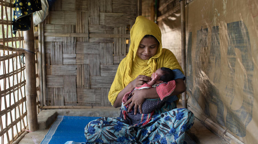 Bangladesh. Community health volunteer helps Rohingya mothers with post-natal care