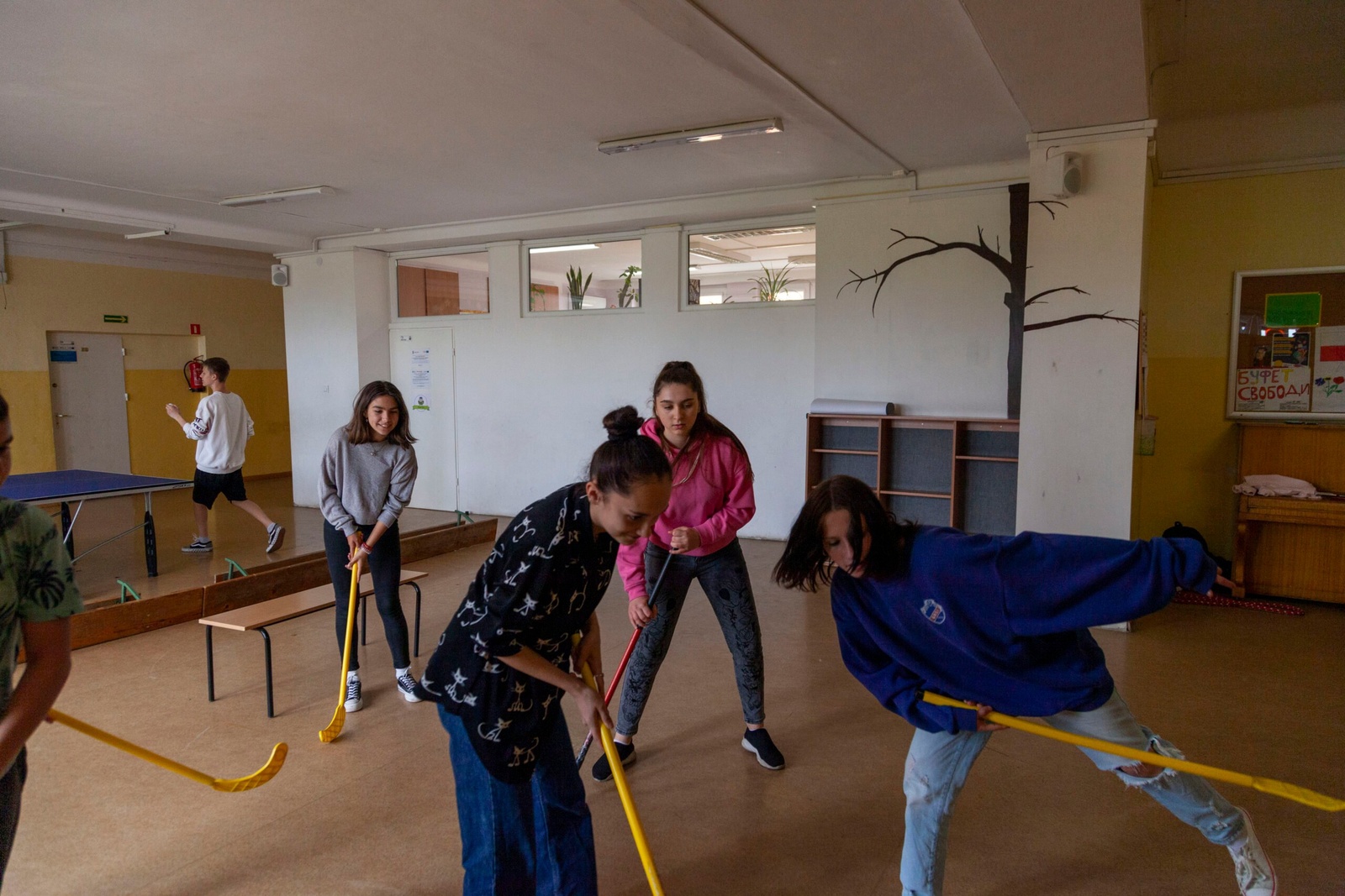 Sofia speelt hockey met haar klasgenoten tijdens de turnles. © UNHCR/Rafal Kostrzynski