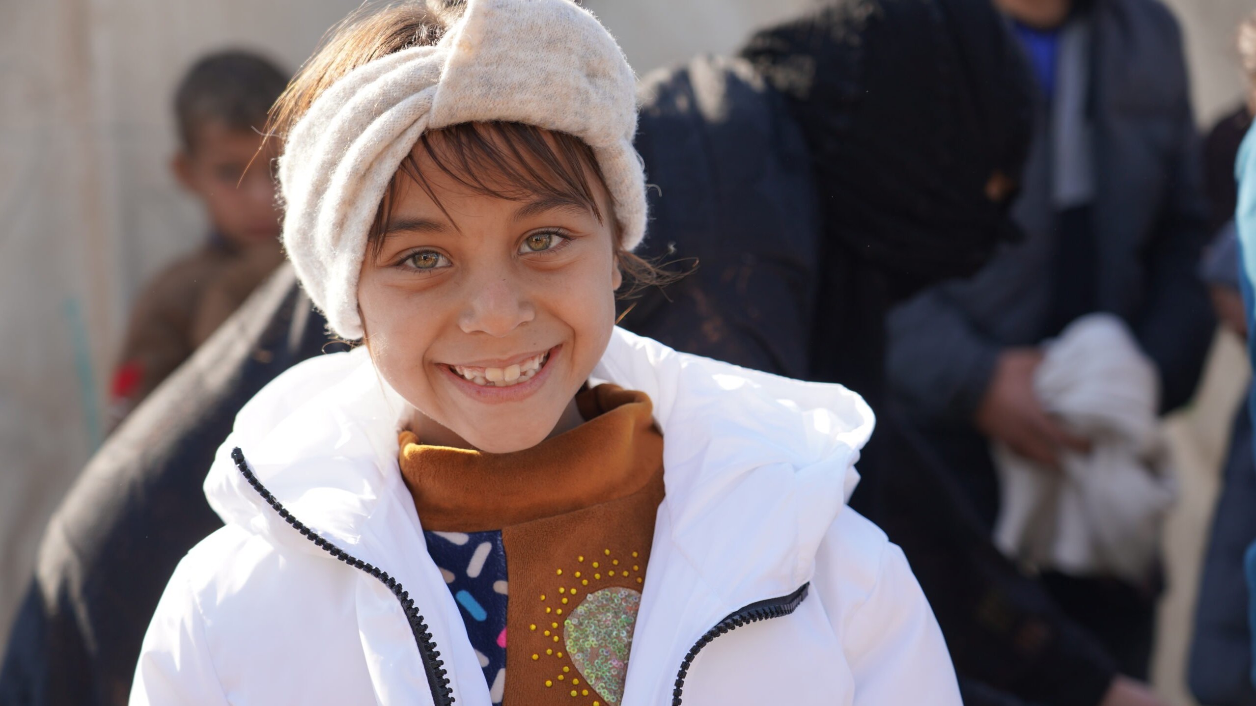 Une jeune fille essaie le manteau d'hiver qu'elle a reçu dans le cadre d'un don de vêtements de H&M. Plus de 250 000 hommes, femmes et enfants contraints de fuir en Irak recevront cet hiver des vêtements de la chaîne de magasins, présente dans le monde entier, pour les garder au chaud pendant les mois d'hiver. © UNHCR
