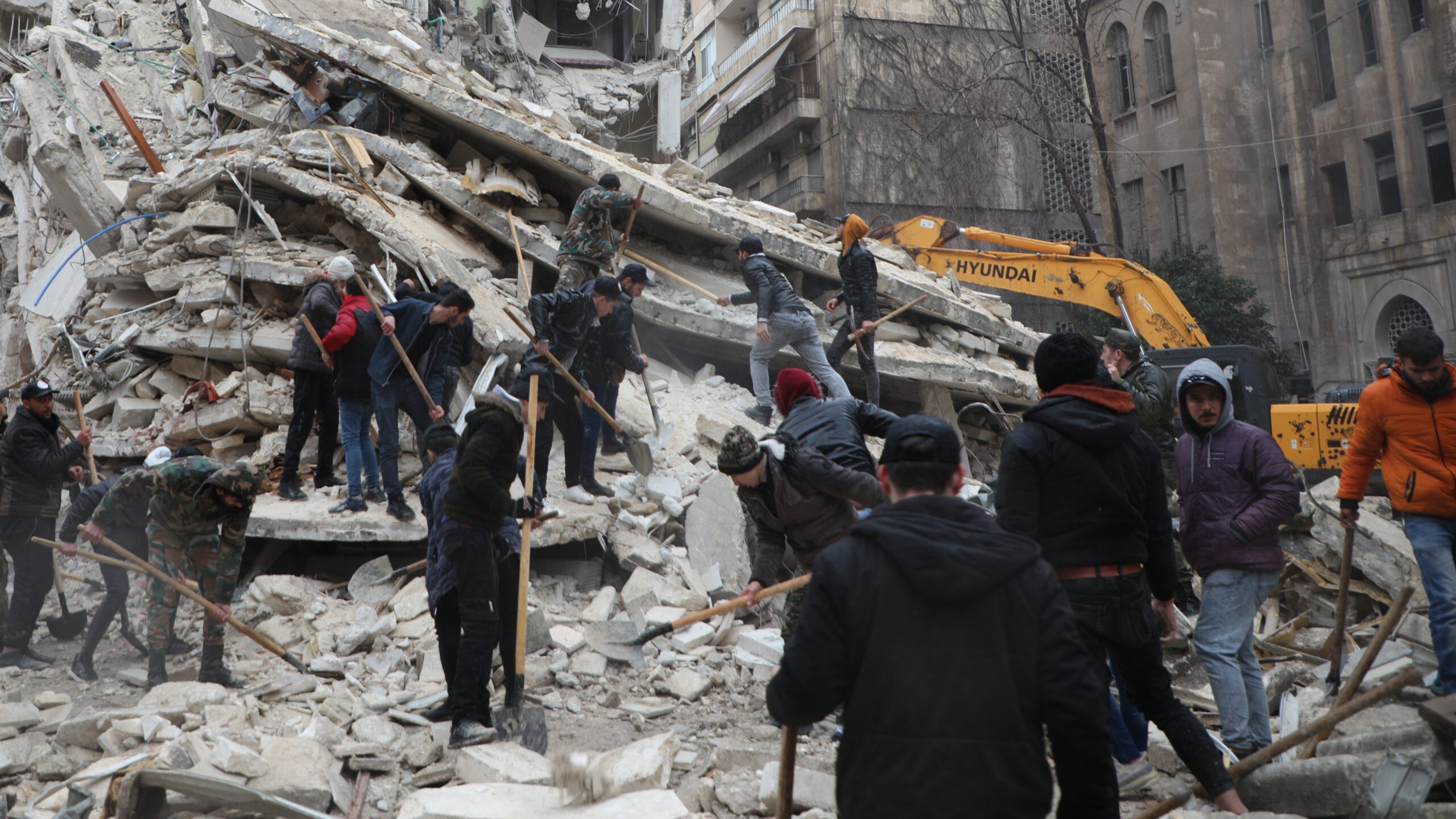 Reddingsteams zoeken naar overlevenden in de ruïnes van een gebouw in de wijk Al-Aziziyeh in Aleppo, Syrië. Onder de slachtoffers bevinden zich ook gezinnen die op het moment van de aardbevingen al ontheemd waren door de langdurige crisis in hun land. © UNHCR/Hameed Maarouf