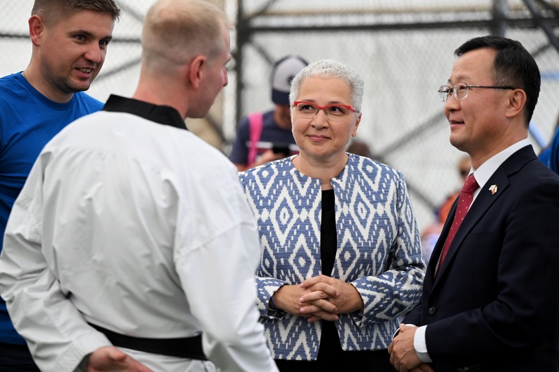 UNHCR Representative and ROK Ambassador talking to UNCHR staff and Taekwondo coach