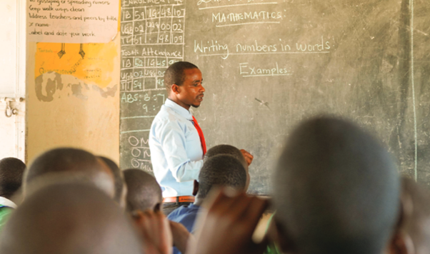 A man standing in front of a chalkboard.