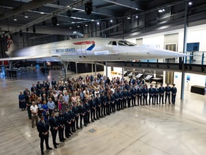 Attendees at a TUI Airline pilot certification ceremony stand in front of a Concorde airliner at Aerospace Bristol, UK.
