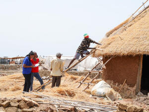 Sudan. Refugee civil engineers supervise shelter construction