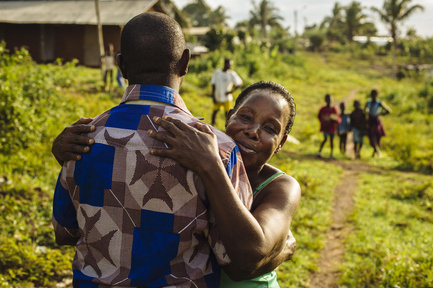 A former refugee from Côte d'Ivoire hugs his aunt.