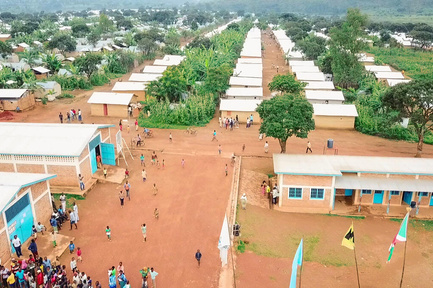 An aerial view of a school in a dusty refugee camp. 