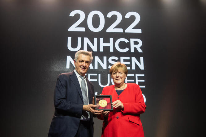 Angela Merkel receiving her award, standing next to Filippo Grandi