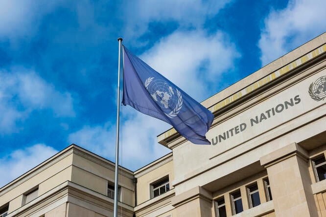 A UN flag flies in front of the Palais des Nations in Geneva. 