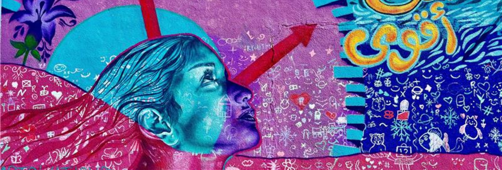 A wall painting in blue and pink shades picturing the head of a woman looking up towards the sky