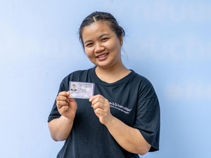 Naw Aung Shaw Paw, a refugee from Myanmar living in Ratchaburi, Thailand, displays her new government-issued identity card.
