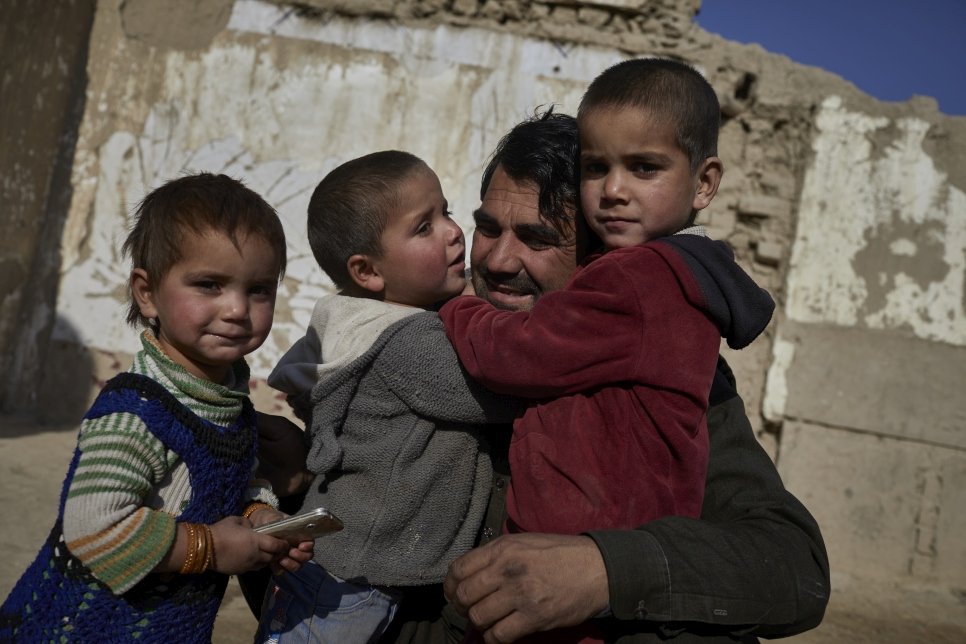 A displaced Afghan father and three of his children