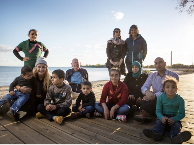 A group of people sitting at. lake