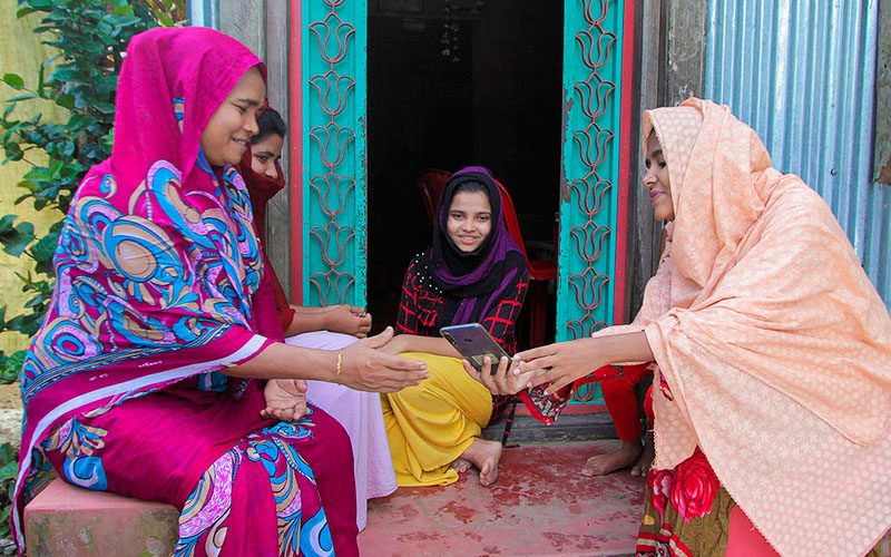 Yesmin Akter, a member of the host community in Cox's Bazar, Bangladesh, receiving cash support from UNHCR during the COVID-19 pandemic.<br />
© UNHCR/Hasib Zuberi