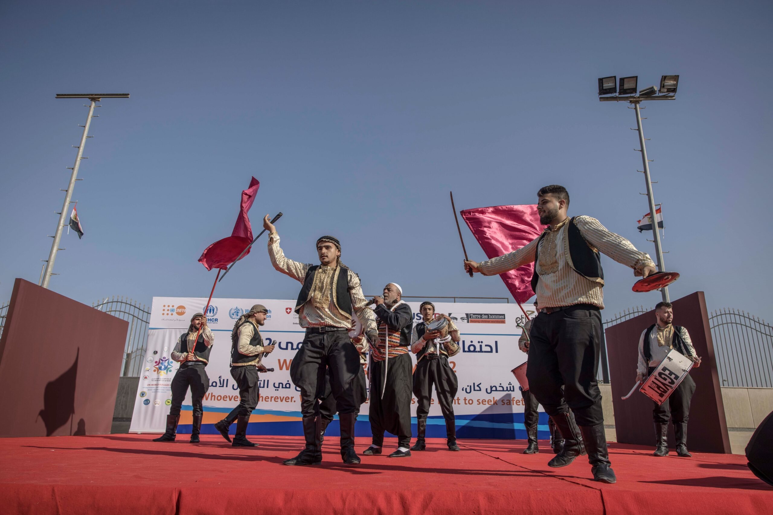 Refugees and asylum-seekers perform a traditional dance during the community event. UNHCR/Pedro Costa Gomes.