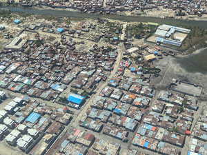 An aerial view of a neighbourhood in Haiti's capital Port-au-Prince shows a densely populated area and a river.