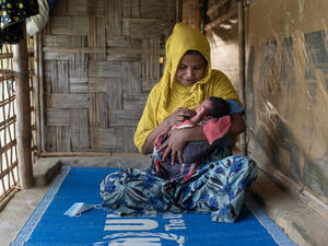 Bangladesh. Community health volunteer helps Rohingya mothers with post-natal care