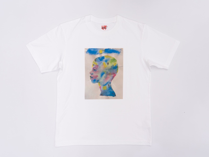 A white t-shirt with an illustration of a face covered in various colors.
