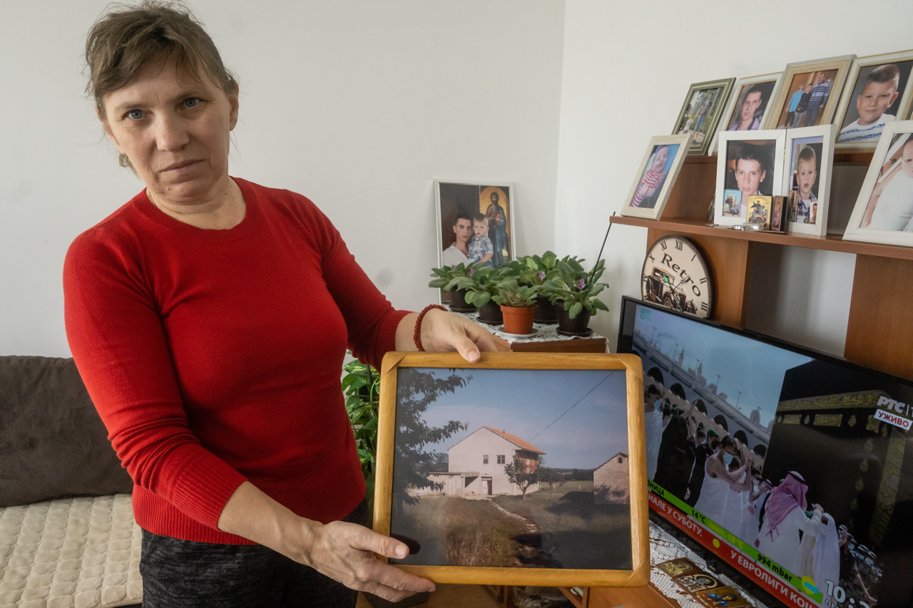 Ljubinka from Croatia living in Serbia shows a photo of her family home in Benkovac, Croatia.